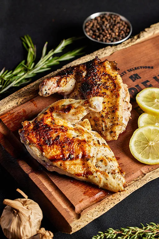 Airline chicken beautifully presented with rosemary, highlighting a gourmet dining experience.