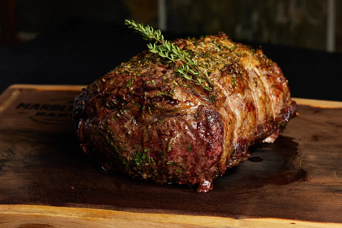 A large boneless prime rib roast resting on a wooden cutting board, highlighting its appearance and quality.