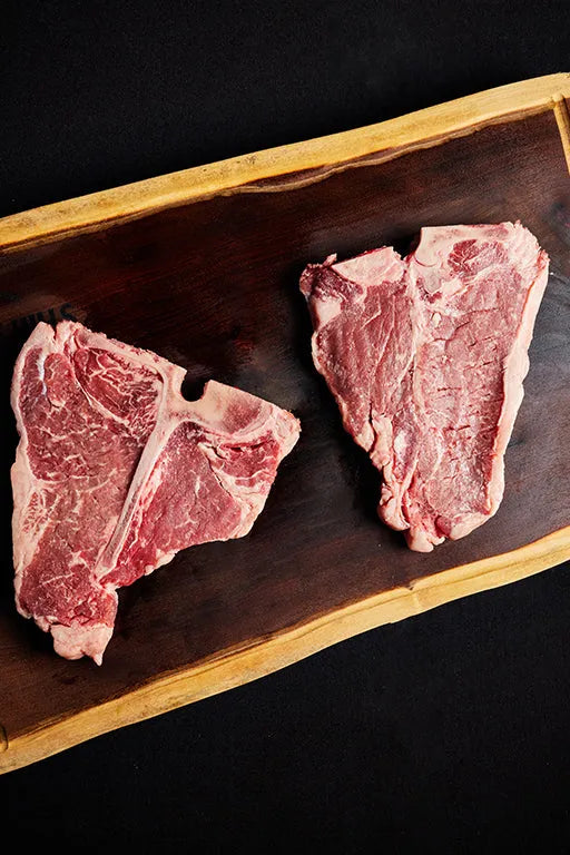 Two USDA Choice T-Bone steaks resting on a cutting board.