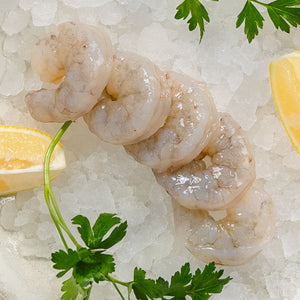 Fresh shrimp on ice garnished with lemon slices.